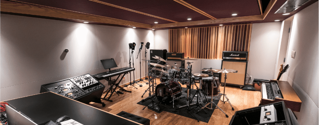 interior shot of music studio, complete with various musical equipment and instruments arranged throughout the room.