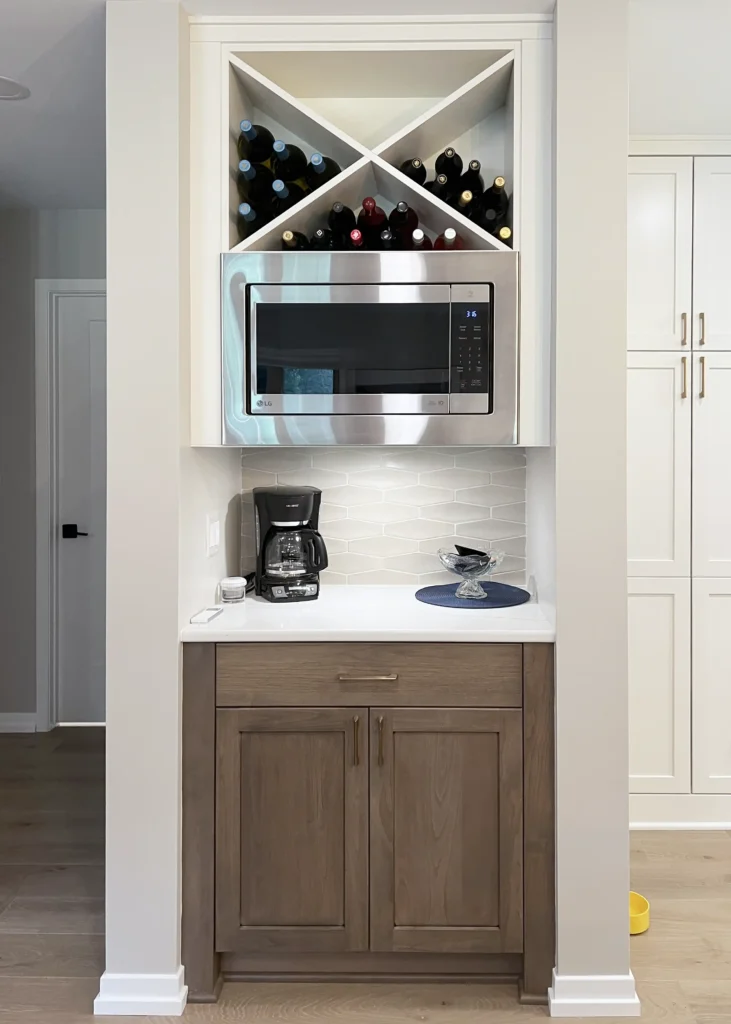 Built-in coffee station with a microwave and wine storage above wood base cabinetry.