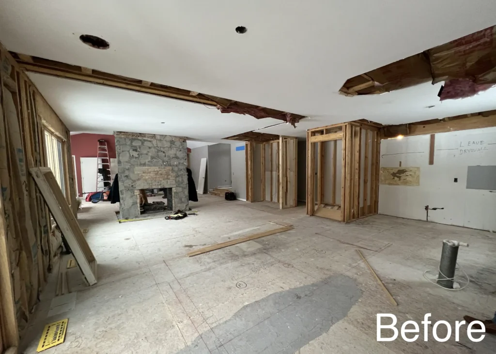 Kitchen demolition exposes wall framing and ceiling openings before rebuilding.